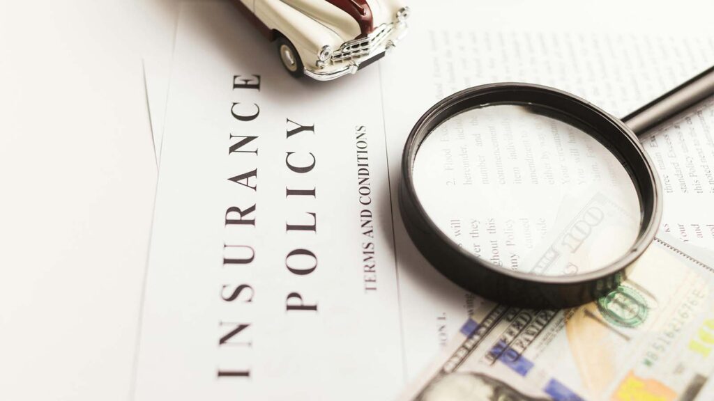 Image or an insurance policy under a magnifying glass.